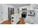 Bright kitchen with stainless steel appliances, granite countertops, and an island at 5909 Royal Coach Ct, Raleigh, NC 27612