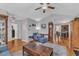 Cozy living room with hardwood floors, grey walls, blue furniture, and open access to the kitchen at 5909 Royal Coach Ct, Raleigh, NC 27612