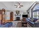 Bright living room features high ceiling, natural light, fireplace, and stylish blue furniture at 5909 Royal Coach Ct, Raleigh, NC 27612