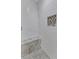 Corner shower with bench seating and textured tile at 5909 Royal Coach Ct, Raleigh, NC 27612