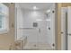 Tiled walk-in shower with glass door, tiled bench, and wall niche at 5909 Royal Coach Ct, Raleigh, NC 27612
