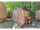 Spacious storage shed with double doors and an adjacent wooden work table at 5909 Royal Coach Ct, Raleigh, NC 27612