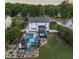 Aerial view of a home showcases a sparkling pool, hot tub, outdoor bar, and lush landscaping in the backyard at 60 Consella Way, Franklinton, NC 27525