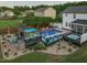 Aerial view of backyard pool area with bar, hot tub, fire pit, and lush landscaping at 60 Consella Way, Franklinton, NC 27525