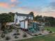 A backyard view featuring an outdoor kitchen, a fire pit, lovely landscaping, and exterior of the home at 60 Consella Way, Franklinton, NC 27525