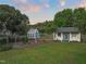 Charming backyard featuring a small greenhouse and shed, set amidst lush greenery at 60 Consella Way, Franklinton, NC 27525