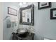Stylish bathroom features a unique vessel sink, ornate mirror, and powder blue walls at 60 Consella Way, Franklinton, NC 27525