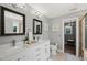 Bright bathroom with double vanity, modern fixtures, and decorative mirrors at 60 Consella Way, Franklinton, NC 27525
