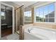 Elegant soaking tub and glass shower in a well-lit bathroom at 60 Consella Way, Franklinton, NC 27525