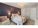 This bedroom is furnished with a floral comforter, a chair, and elegant lighting at 60 Consella Way, Franklinton, NC 27525