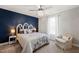 Stylish bedroom with navy accent wall, designer lighting, and cozy seating at 60 Consella Way, Franklinton, NC 27525