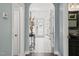 Elegant foyer featuring white tile flooring and an arched entryway with a beautiful view at 60 Consella Way, Franklinton, NC 27525
