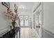 Elegant foyer boasts white tile flooring, beautiful doors with glass, and sophisticated decorations at 60 Consella Way, Franklinton, NC 27525
