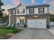 Charming two-story home featuring a stone facade, a two-car garage, and a well-manicured lawn at 60 Consella Way, Franklinton, NC 27525