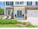 Welcoming home entrance boasts double turquoise doors, stone accents, and a manicured front yard at 60 Consella Way, Franklinton, NC 27525