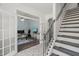 View of stairway landing and home office through french doors, with decorative tile and wood flooring at 60 Consella Way, Franklinton, NC 27525