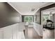 Bright hallway featuring wainscoting, hardwood floors and a window seat by a large window at 60 Consella Way, Franklinton, NC 27525