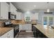 Well-lit kitchen featuring stainless steel appliances, granite countertops, and white cabinets for a modern design at 60 Consella Way, Franklinton, NC 27525
