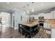 Bright kitchen featuring white cabinets, granite countertops, and an island with seating for a cozy and modern feel at 60 Consella Way, Franklinton, NC 27525