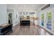 Open-concept kitchen featuring an island with seating, stainless steel appliances, and access to the outdoor patio at 60 Consella Way, Franklinton, NC 27525