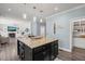 Spacious kitchen island with granite countertop, ample seating, and open view into the living area at 60 Consella Way, Franklinton, NC 27525
