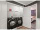 This laundry room includes a modern washer and dryer, with white trim and wainscoting at 60 Consella Way, Franklinton, NC 27525