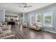 Open-concept living room with hardwood floors and backyard view, flowing seamlessly into the kitchen at 60 Consella Way, Franklinton, NC 27525