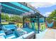 Outdoor bar and lounge area with colorful seating, a fire pit, and a covered pergola for relaxation and entertaining at 60 Consella Way, Franklinton, NC 27525