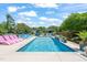 Sparkling in-ground pool surrounded by stylish loungers and a bar area, creating a serene backyard retreat at 60 Consella Way, Franklinton, NC 27525