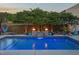 A tranquil waterfall feature cascading into the pool, complemented by elegant fire bowls and lush greenery at 60 Consella Way, Franklinton, NC 27525