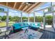 Relax on this screened porch furnished with a sectional sofa and enjoy the backyard view at 60 Consella Way, Franklinton, NC 27525