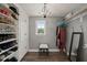 Organized walk-in closet with custom shelving and a stylish chandelier at 60 Consella Way, Franklinton, NC 27525