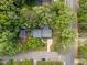 An aerial view of a home with mature trees, a long driveway, and a spacious front yard at 600 Longleaf Dr, Chapel Hill, NC 27517