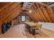 Finished attic space with wood floors, natural light, table, and storage at 600 Longleaf Dr, Chapel Hill, NC 27517