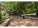 Wooden deck with built-in benches, grill, garden, and shed in the backyard at 600 Longleaf Dr, Chapel Hill, NC 27517