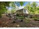 A spacious backyard with a fire pit, lush greenery, and a screened porch for outdoor living at 600 Longleaf Dr, Chapel Hill, NC 27517