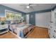 Comfortable bedroom with hardwood floors, ceiling fan, and ample natural light at 600 Longleaf Dr, Chapel Hill, NC 27517