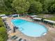 A large community pool with plenty of lounge chairs, covered seating, and mature landscaping at 600 Longleaf Dr, Chapel Hill, NC 27517