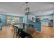 Open-concept dining area with a large wooden table and modern lighting, flowing seamlessly into the kitchen and living room at 600 Longleaf Dr, Chapel Hill, NC 27517