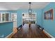 Dining area with a long wooden table, modern light fixture, and large windows, perfect for entertaining guests at 600 Longleaf Dr, Chapel Hill, NC 27517