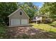 View of a detached garage and the home featuring mature trees and a spacious yard at 600 Longleaf Dr, Chapel Hill, NC 27517