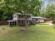 A large two-story home with a mix of siding and brick, complimented by mature trees and landscaping at 600 Longleaf Dr, Chapel Hill, NC 27517