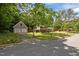 Charming home with mature trees, a spacious yard, and detached garage at 600 Longleaf Dr, Chapel Hill, NC 27517