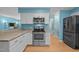 Bright kitchen boasts stainless steel appliances, granite countertops, and crisp white cabinetry at 600 Longleaf Dr, Chapel Hill, NC 27517