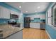 Well-lit kitchen with stainless steel appliances, granite countertops, and white cabinets, providing a modern cooking space at 600 Longleaf Dr, Chapel Hill, NC 27517
