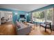 Light-filled living room with hardwood floors, a comfortable sofa, and large windows offering a view of the outdoors at 600 Longleaf Dr, Chapel Hill, NC 27517
