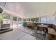 Enclosed patio with seating, concrete floors, and views of the backyard at 600 Longleaf Dr, Chapel Hill, NC 27517