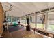 Bright sunroom with exercise equipment, brick accent wall, and windows at 600 Longleaf Dr, Chapel Hill, NC 27517