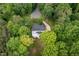 A high angle displays the home with a deck surrounded by lots of mature trees at 7000 Millstone Ridge Ct, Raleigh, NC 27614