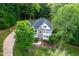 Stunning aerial view of a two-story home with a landscaped yard and long driveway at 7000 Millstone Ridge Ct, Raleigh, NC 27614